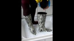 Jana write on fill and messy her zebra rubber boots in the shower trailer